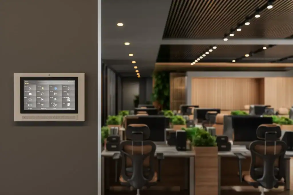 Modern office workspace with digital control panel, ergonomic chairs, and collaborative workstations in a contemporary, well-lit environment emphasizing innovative office design and interior architecture.